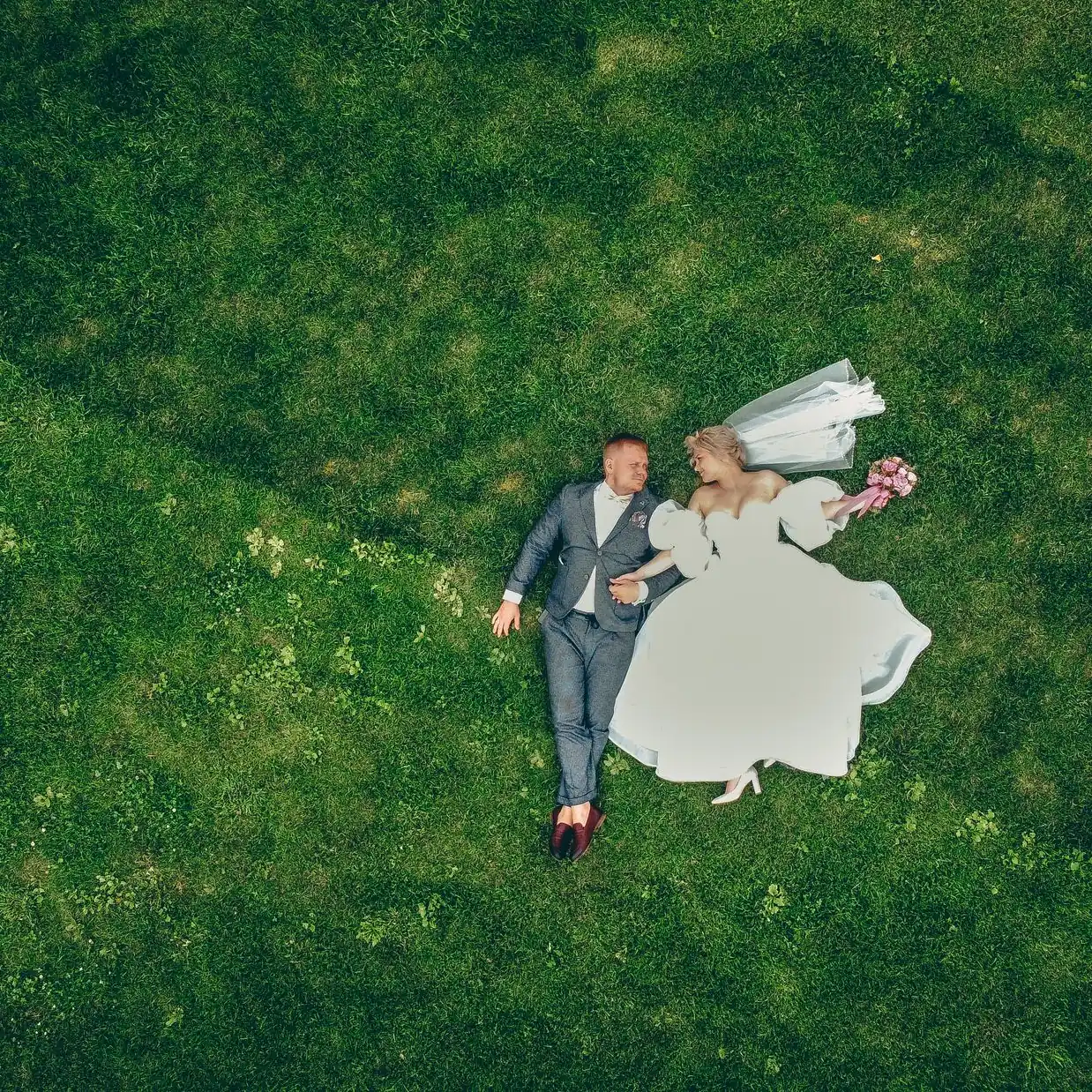 Bridal party crossing a meadow, top-down